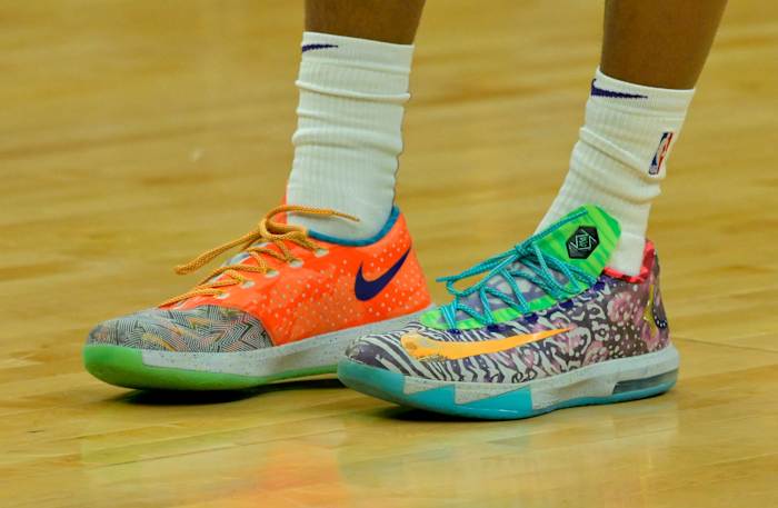 View of orange and green Nike KD shoes.